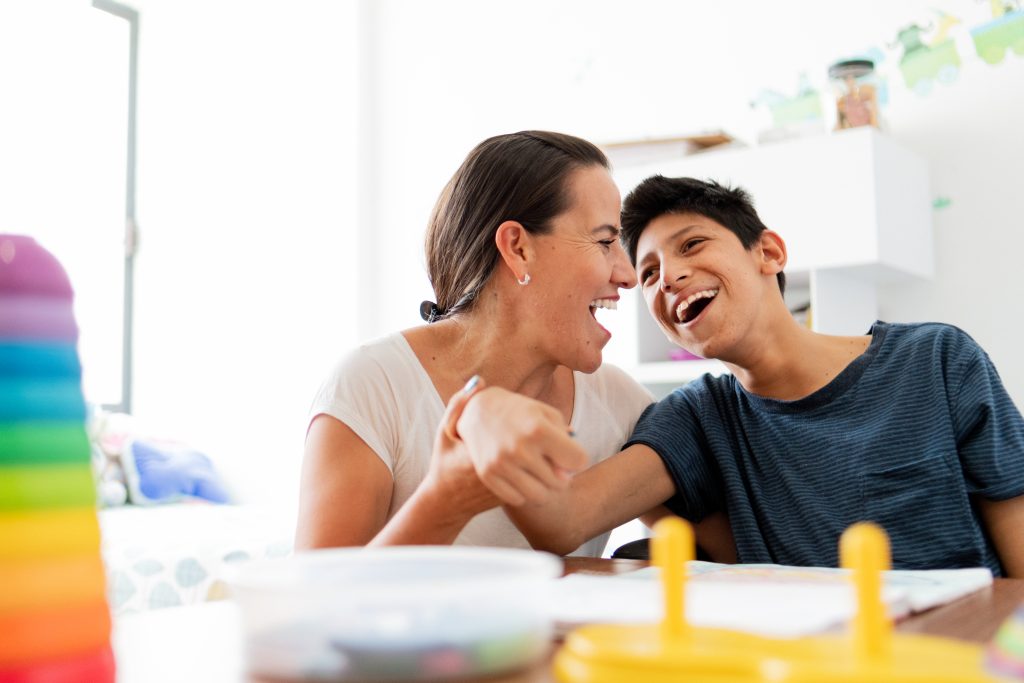 Mother drawing with son with Cerebral Palsy