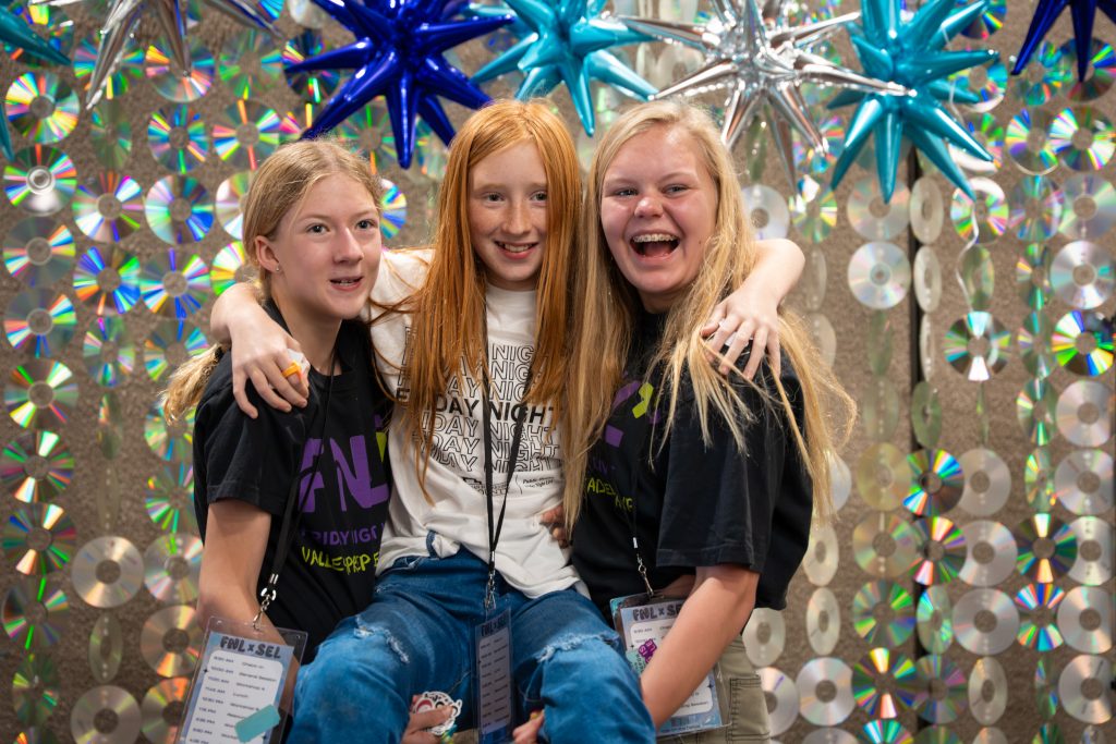 Girls smiling with shiny cd background