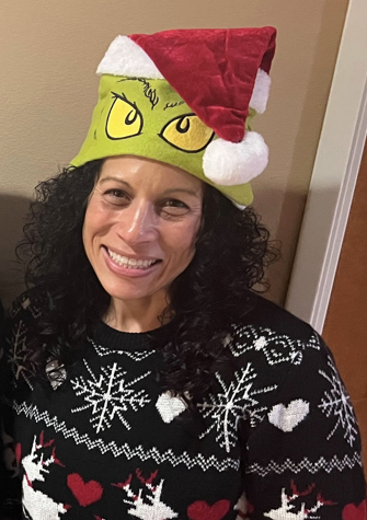 Health educator, Marilyn Alicea, wearing a Christmas sweater and hat. 