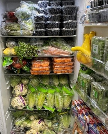 A refrigerator filled with fresh produce from the Community Heart Food Pantry.