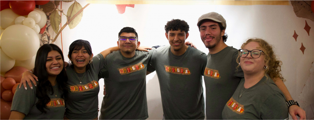 A group of young adults smile and pose 