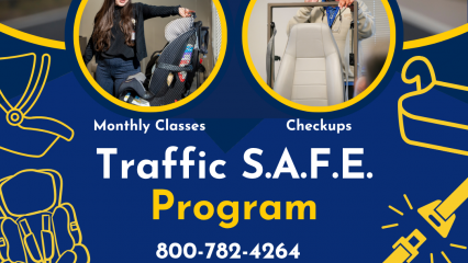 A promotional graphic for the Traffic S.A.F.E. Program. The top half shows two circular photos: one of an individual demonstrating how to secure a child safety seat, and another of an individual adjusting a vehicle seat structure during a safety check. Surrounding the images are simple yellow line drawings of car seats and seat belts. Text reads “Monthly Classes” and “Checkups.” Below the photos, large text says “Traffic S.A.F.E. Program” with the phone number 800‑782‑4264. The bottom of the graphic displays the Traffic S.A.F.E. Program logo featuring icons of different child seats, the San Bernardino County logo, and the Public Health Health Promotion and Education division name. The background includes a stylized roadway and dark blue/yellow design elements.