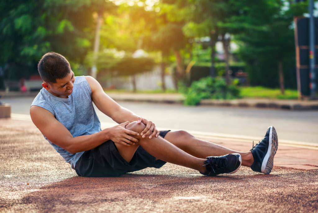 A man who was outside in the heat gets a muscle cramp and has to lie down.